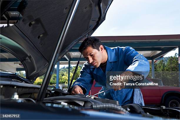 middle eastern mechanic working on car engine - auto repair shop background stock pictures, royalty-free photos & images