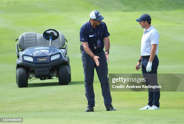Rory McIlroy of Northern Ireland is given a ruling by DP World Tour Senior Referee Kevin Feeney on the first hole on Day Three of the DS Automobiles...