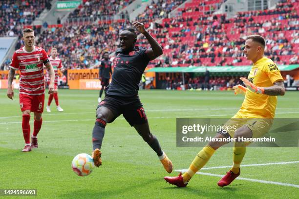 Sadio Mane of Bayern Munich battles for possession with Rafal Gikiewicz of FC Augsburg during the Bundesliga match between FC Augsburg and FC Bayern...