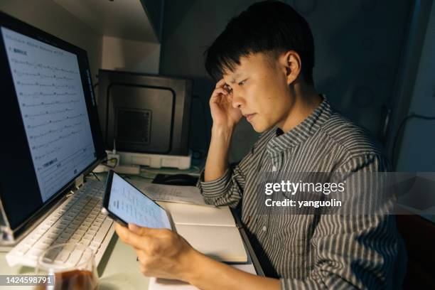 a man stayed up all night studying and working - china exam imagens e fotografias de stock