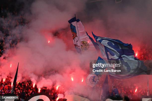 Schalke 04 fans burn flares during the Bundesliga match between Borussia Dortmund and FC Schalke 04 at Signal Iduna Park on September 17, 2022 in...