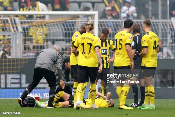 Marco Reus of Borussia Dortmund receives medical treatment during the Bundesliga match between Borussia Dortmund and FC Schalke 04 at Signal Iduna...