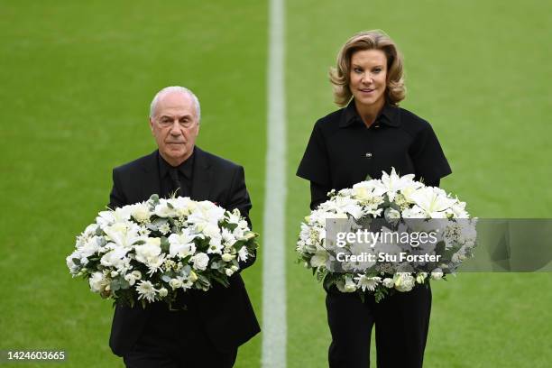 Jeff Mostyn, Chairperson of AFC Bournemouth and Amanda Staveley, Co-Owner of Newcastle United hold a reath to pay tribute to Her Majesty Queen...