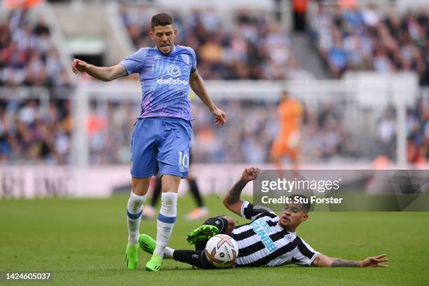 Ryan Christie of AFC Bournemouth is challenged by Bruno Guimaraes of Newcastle United during the Premier League match between Newcastle United and...