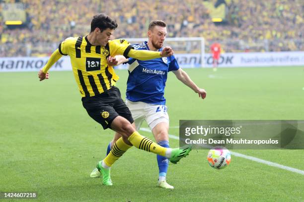 Giovanni Reyna of Borussia Dortmund passes while under pressure from Tobias Mohr of FC Schalke 04 during the Bundesliga match between Borussia...