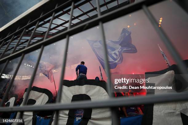 Schalke 04 fans burn flares during the Bundesliga match between Borussia Dortmund and FC Schalke 04 at Signal Iduna Park on September 17, 2022 in...