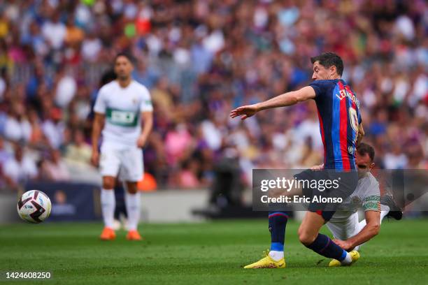 Robert Lewandowski FC Barcelona is tackled by Gonzalo Verdu of Elche CF during the LaLiga Santander match between FC Barcelona and Elche CF at...