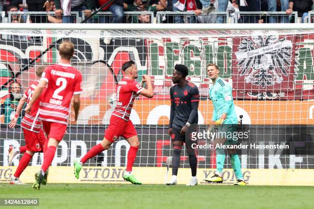 Mergim Berisha of FC Augsburg celebrates after scoring their team's first goal during the Bundesliga match between FC Augsburg and FC Bayern München...