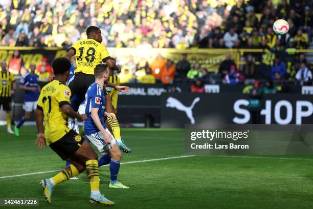 Youssoufa Moukoko of Borussia Dortmund scores their team's first goal during the Bundesliga match between Borussia Dortmund and FC Schalke 04 at...