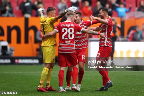 Rafal Gikiewicz, Andre Hahn, Elvis Rexhbecaj and Maximilian Bauer of FC Augsburg celebrate victory following the Bundesliga match between FC Augsburg...