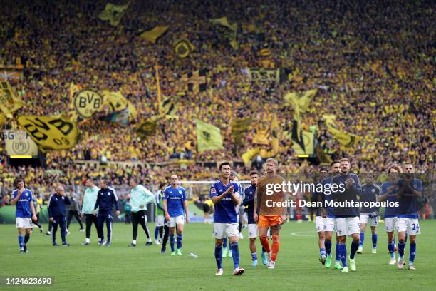 Maya Yoshida of FC Schalke 04 applauds the fans with teammates following their sides defeat in the Bundesliga match between Borussia Dortmund and FC...