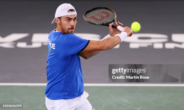 Benjamin Bonzi of France plays a backhand against David Goffinof Belgium during the Davis Cup Group Stage 2022 Hamburg match between France and...