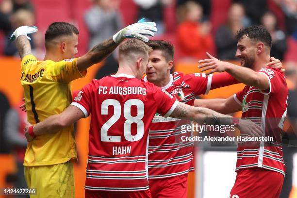 Players of Augsburg celebrate winning the Bundesliga match between FC Augsburg and FC Bayern München at WWK-Arena on September 17, 2022 in Augsburg,...