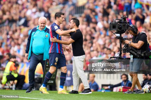 Robert Lewandowski of FC Barcelona greets his head Xavi Hernandez as he leaves the pitch during the LaLiga Santander match between FC Barcelona and...