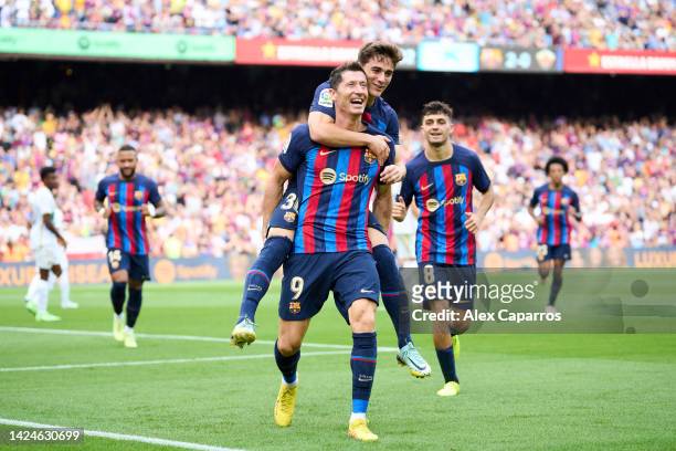 Robert Lewandowski of FC Barcelona celebrates with his teammates Pablo Paez Gavira 'Gavi' of FC Barcelona after scoring his team's third goal during...