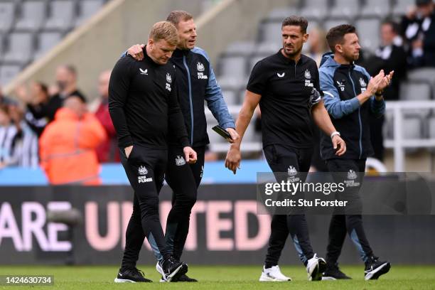 Eddie Howe, Manager of Newcastle United looks dejected as Graeme Jones, Assistant Manager of Newcastle United consoles him after the Premier League...