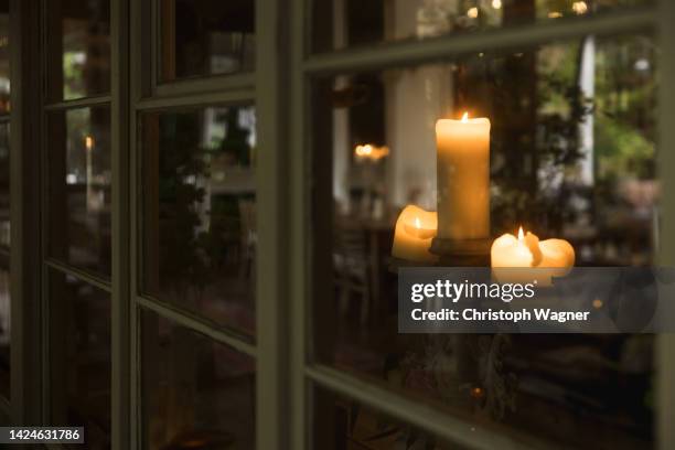 candle, window, cosy, autumn - night in fotografías e imágenes de stock