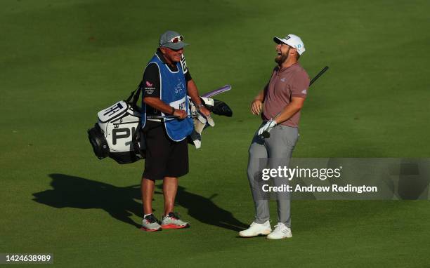 Tyrrell Hatton of England and his caddie Kyle Roadley share a joke on the 18th hole on Day Three of the DS Automobiles Italian Open 2022 at Marco...