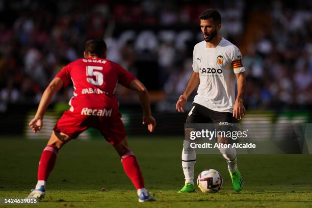 Jose Gaya of Valencia CF is put under pressure by Oscar Rodriguez of RC Celta during the LaLiga Santander match between Valencia CF and RC Celta at...