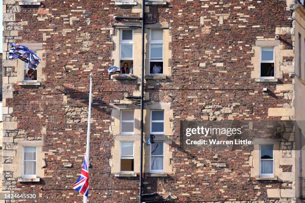 Bath Supports wave flags outside their homes as the Union Jack flag is flown at half mast in memory for Her Majesty Queen Elizabeth II during the...