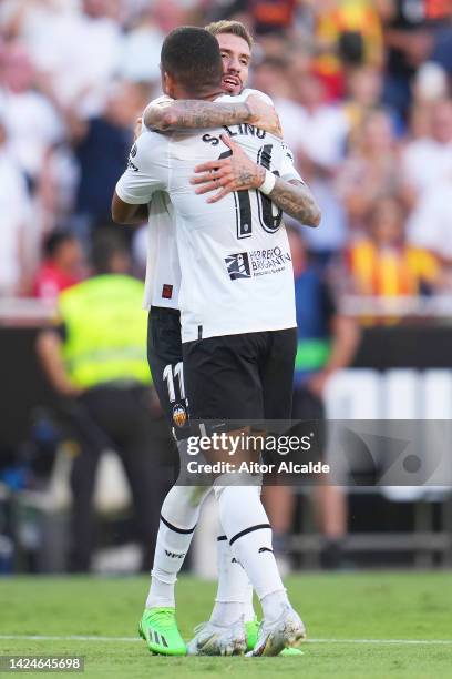 Samu Castillejo of Valencia CF celebrates with teammate Samuel Lino after scoring their team's first goal during the LaLiga Santander match between...