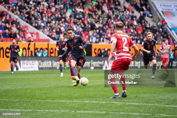 Jamal Musiala of FC Bayern Muenchen controls the ball during the Bundesliga match between FC Augsburg and FC Bayern München at WWK-Arena on September...