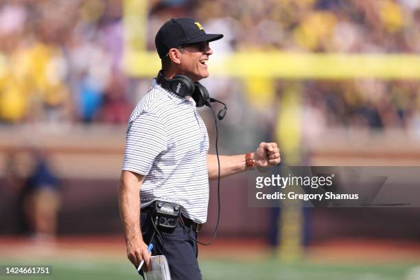 Head coach Jim Harbaugh of the Michigan Wolverines celebrates his teams first half touchdown while playing the Connecticut Huskies at Michigan...