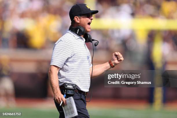 Head coach Jim Harbaugh of the Michigan Wolverines celebrates his teams first half touchdown while playing the Connecticut Huskies at Michigan...