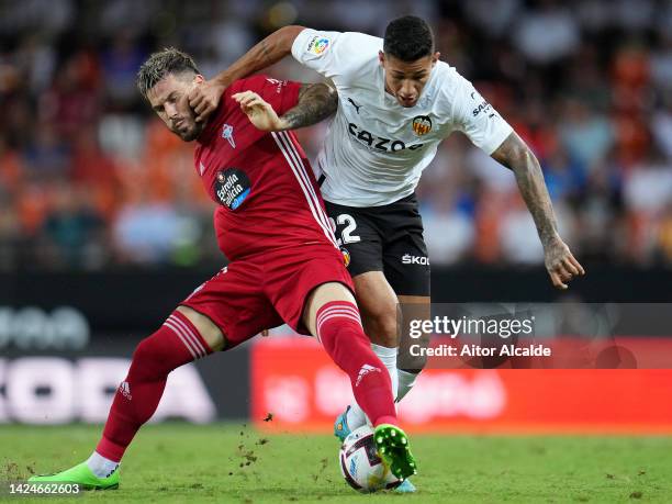 Marcos Andre of Valencia is challenged by Carles Perez of Celta during the LaLiga Santander match between Valencia CF and RC Celta at Estadio...