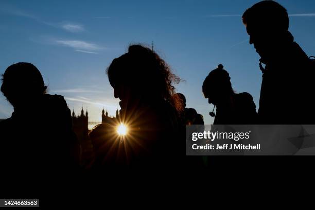 Members of the public queue at Westminster Bridge, to see Queen Elizabeth II lying in state in Westminster Hall on September 17, 2022 in Various...