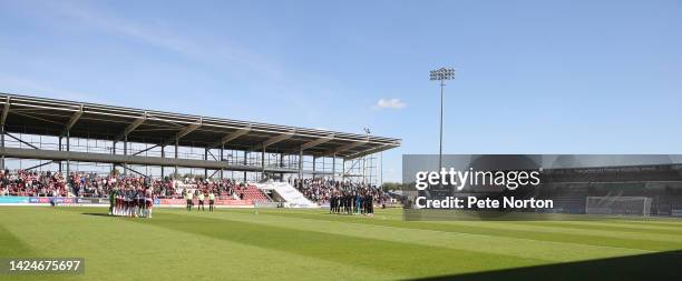 Northampton Town and Rochdale players line up to observe a minutes silence for HM Queen Elizabeth II prior to the Sky Bet League Two between...