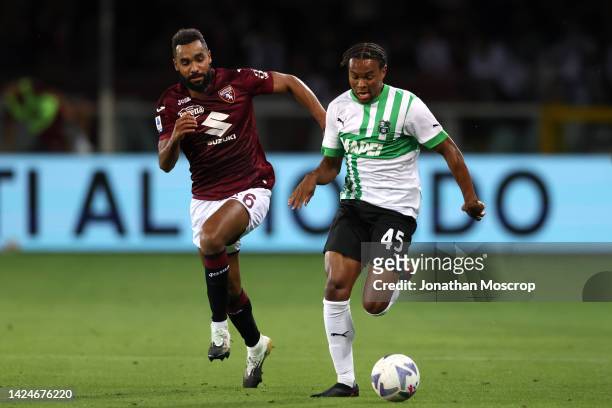 Armand Lauriente of US Sassuolo is pursued by Djidji Koffi of Torino FC during the Serie A match between Torino FC and US Sassuolo at Stadio Olimpico...