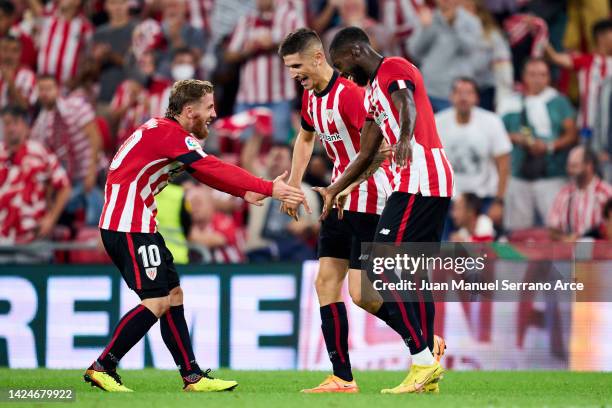 Oihan Sancet of Athletic Club celebrates with his teammates Iker Muniain and Inaki Williams of Athletic Club after scoring his team's second goal...