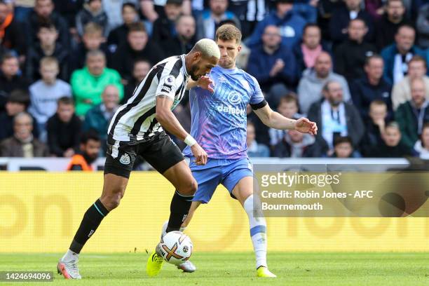 Chris Mepham of Bournemouth closes down Joelinton of Newcastle United during the Premier League match between Newcastle United and AFC Bournemouth at...