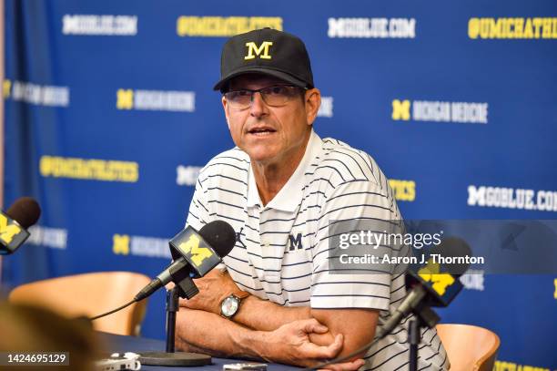 Head Football Coach Jim Harbaugh of the Michigan Wolverines speaks to the media after a college football game against the Connecticut Huskies at...