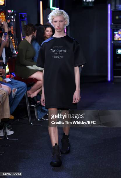 Model walks the runway wearing a tribute to Queen Elizabeth II on their t-shirt at the JW Anderson show during London Fashion Week September 2022 on...