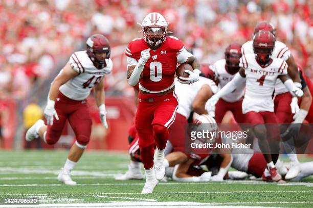 Braelon Allen of the Wisconsin Badgers scores on a 39-yard touchdown run in the first quarter against the New Mexico State Aggies at Camp Randall...