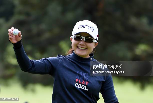 Ayako Uehara of Japan shows the ball to the gallery after hitting a hole-in-one on the second hole during round three of the AmazingCre Portland...