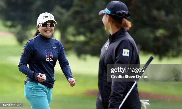 Ayako Uehara of Japan shows the ball to the gallery after hitting a hole-in-one on the second hole as Hinako Shibuno of Japan looks on during round...