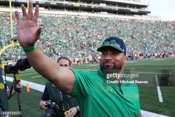 Former Notre Dame Fighting Irish player Manti Te'o waves to fans during the second half against the California Golden Bears at Notre Dame Stadium on...