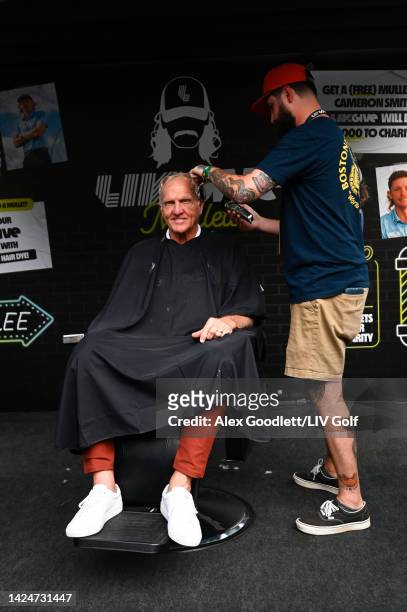 Greg Norman, CEO and commissioner of LIV Golf, receives a mullet haircut at the LIV Gives booth during Day Two of the LIV Golf Invitational - Chicago...
