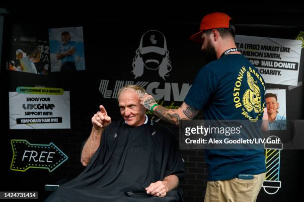 Greg Norman, CEO and commissioner of LIV Golf, receives a mullet haircut at the LIV Gives booth during Day Two of the LIV Golf Invitational - Chicago...
