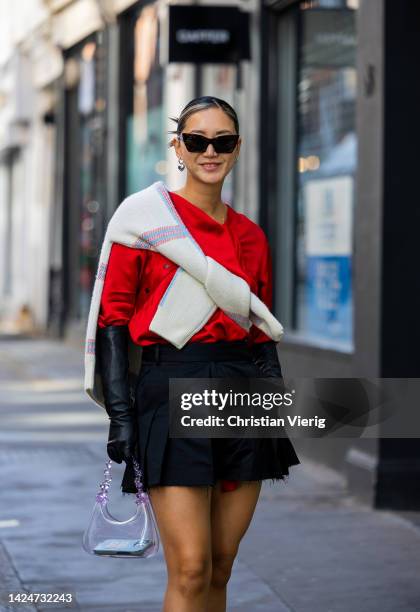 Betty Bachz wears red top, black gloves, mini skirt, see trough bag outside Eudon Choi during London Fashion Week September 2022 on September 17,...