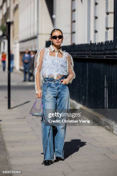 Betty Bachz wears denim jeans, see trough bag, top outside Paul & Joe during London Fashion Week September 2022 on September 17, 2022 in London,...