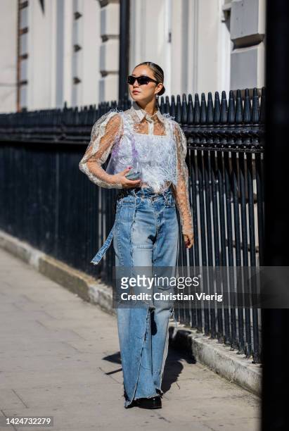 Betty Bachz wears denim jeans, see trough bag, top outside Paul & Joe during London Fashion Week September 2022 on September 17, 2022 in London,...