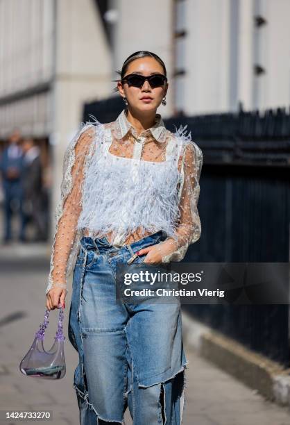 Betty Bachz wears denim jeans, see trough bag, top outside Paul & Joe during London Fashion Week September 2022 on September 17, 2022 in London,...