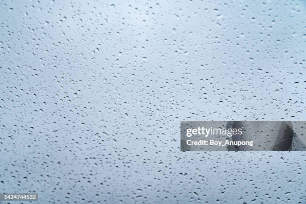 an abstract of water drop on the window glass during raining. - windows surface stock pictures, royalty-free photos & images