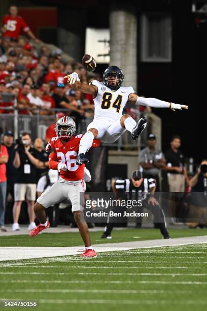 Thomas Zsiros of the Toledo Rockets is knocked off balance by Cameron Brown of the Ohio State Buckeyes during the second quarter of a game at Ohio...