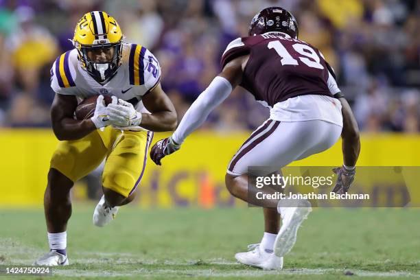 Josh Williams of the LSU Tigers runs with the ball as Collin Duncan of the Mississippi State Bulldogs defends during the second half of a game at...