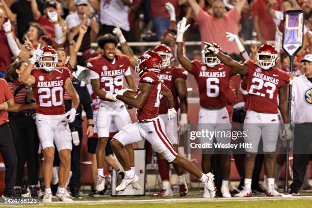 Bryce Stephens of the Arkansas Razorbacks runs the ball in for a touchdown in front of his bench during the second half of game against the Missouri...